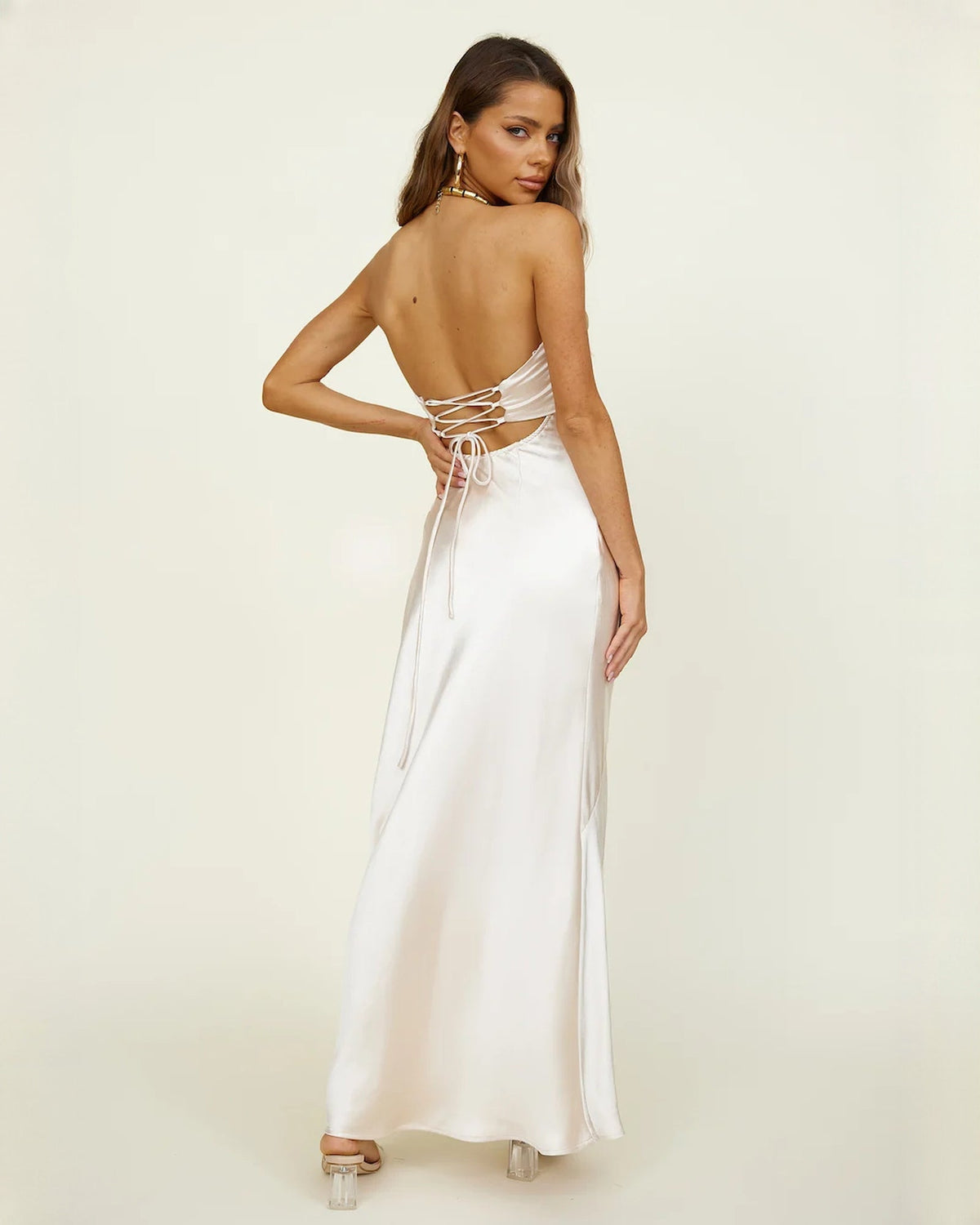 Ivory satin open-back bridesmaid maxi dress with crisscross tie-back straps and long skirt