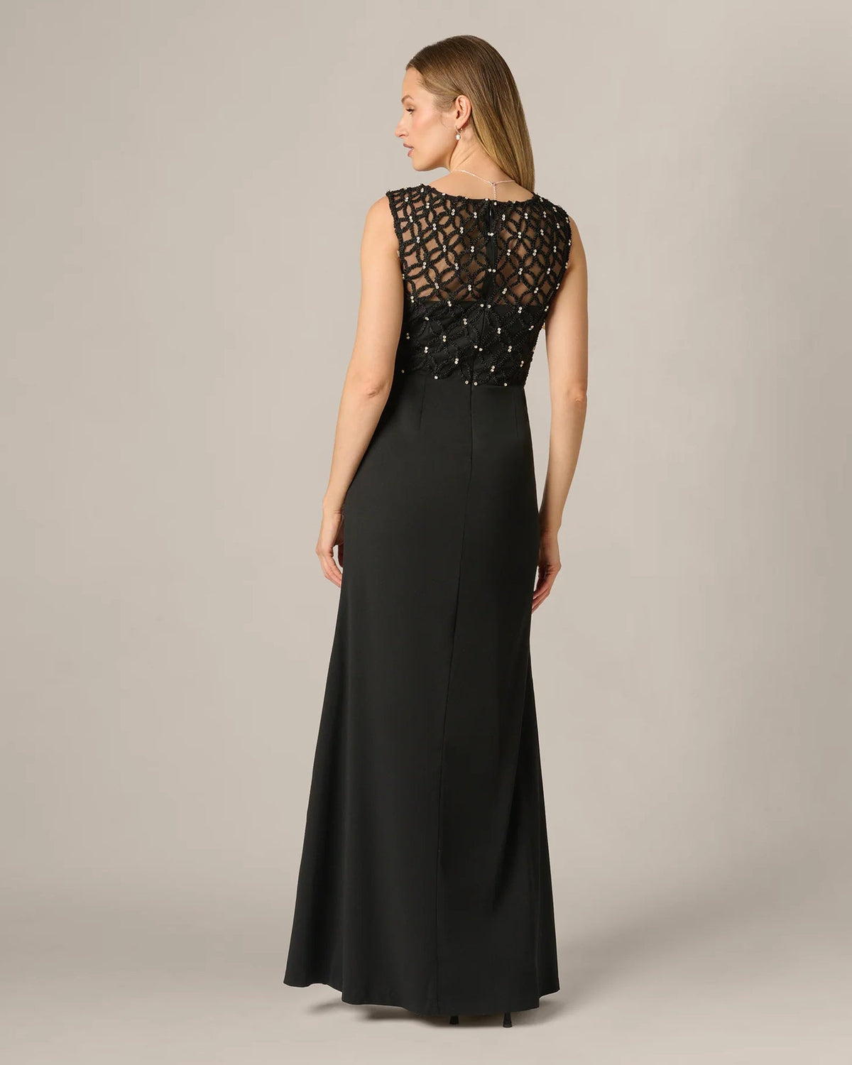 Black sleeveless maxi dress with lace back panel and draped A-line silhouette