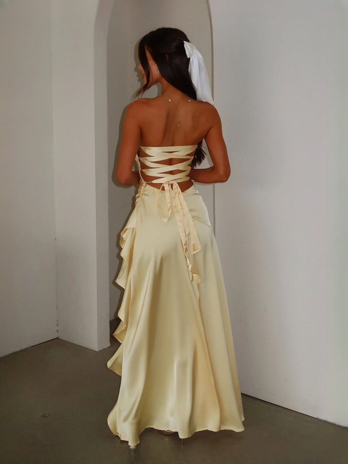 Pale yellow satin prom dress with crisscross lace-up open back and ruffled A-line