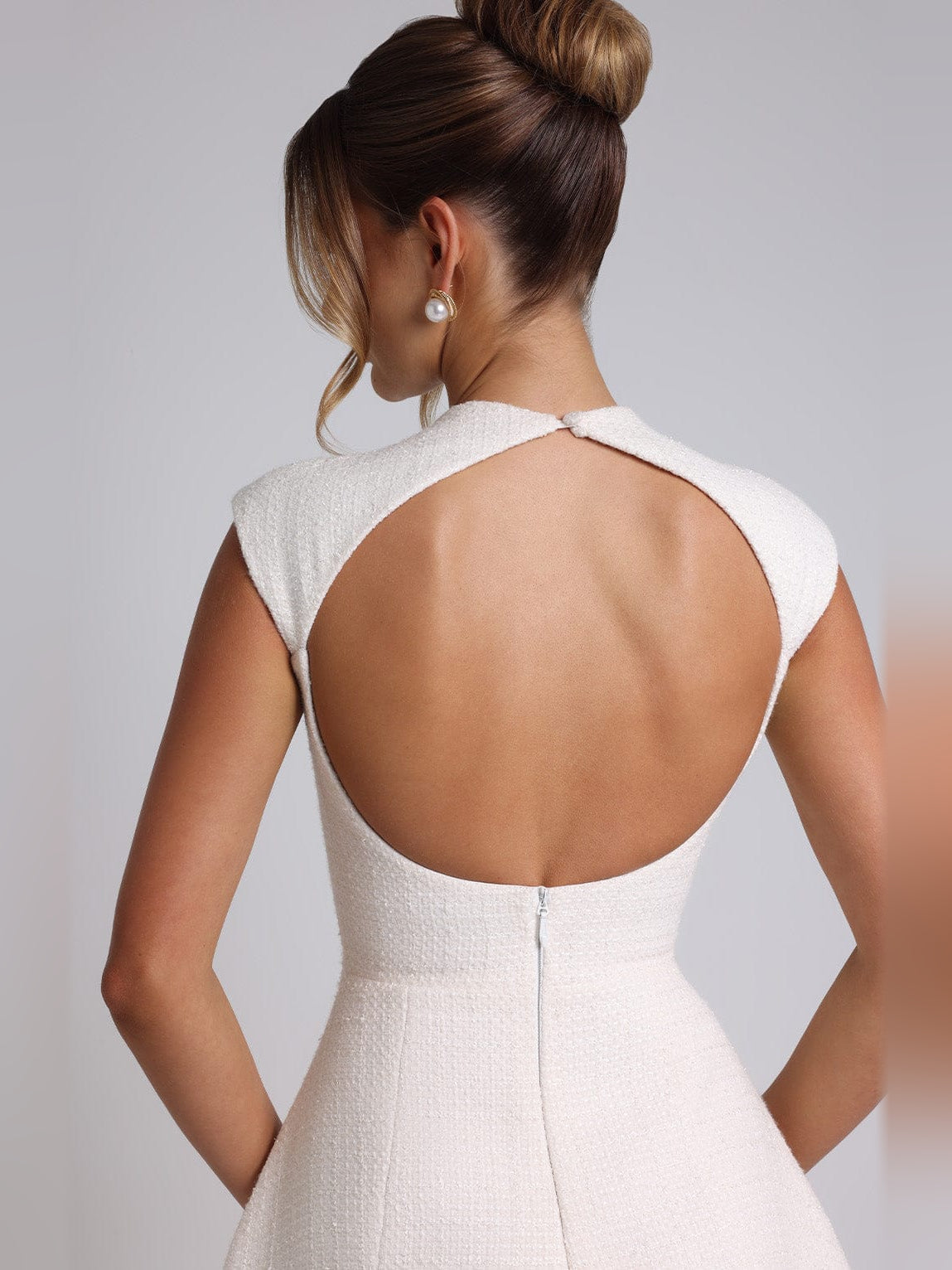 Ivory textured mini dress with open back scoop and sleeveless high-neck top