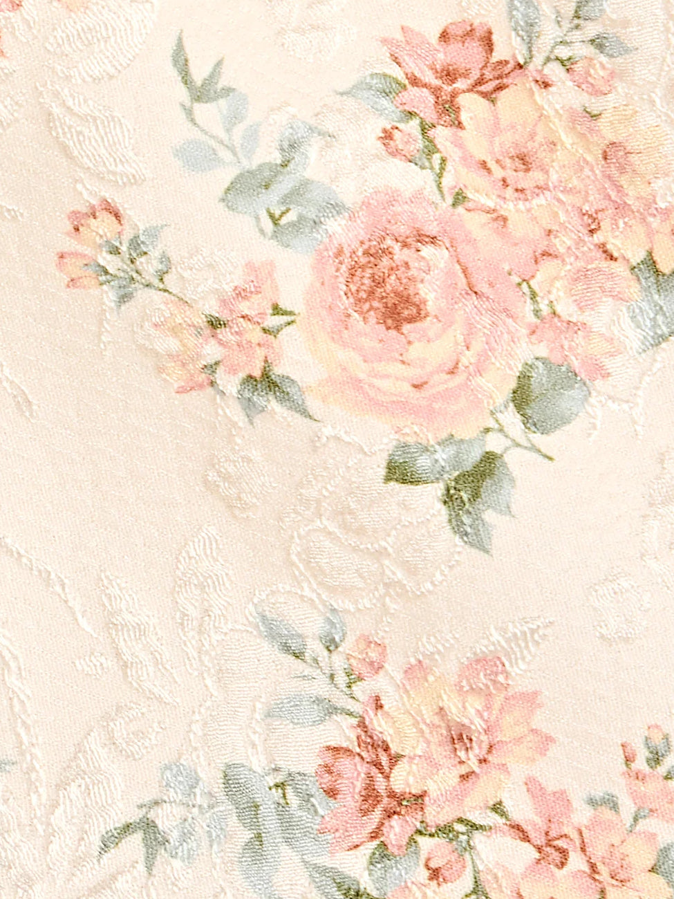 Floral printed fabric close-up with pink, peach, and green blossoms