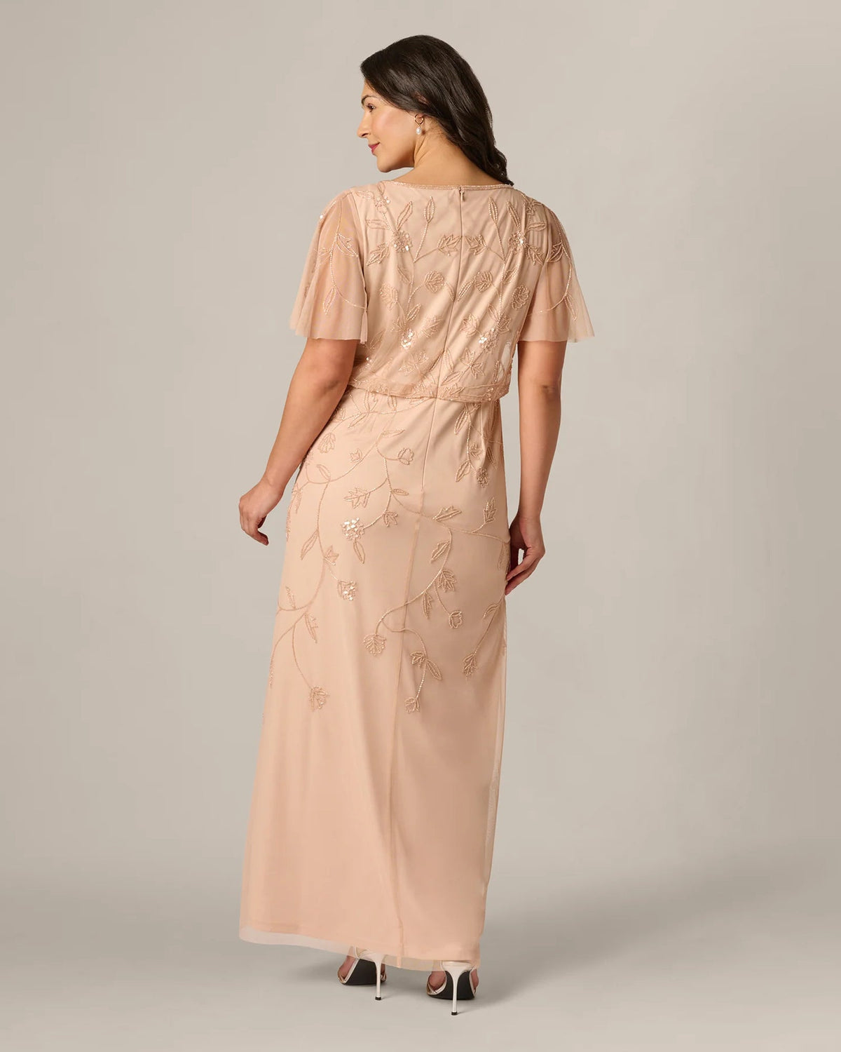 Blush pink A-line maxi dress from back with flutter sleeves and embroidered detail