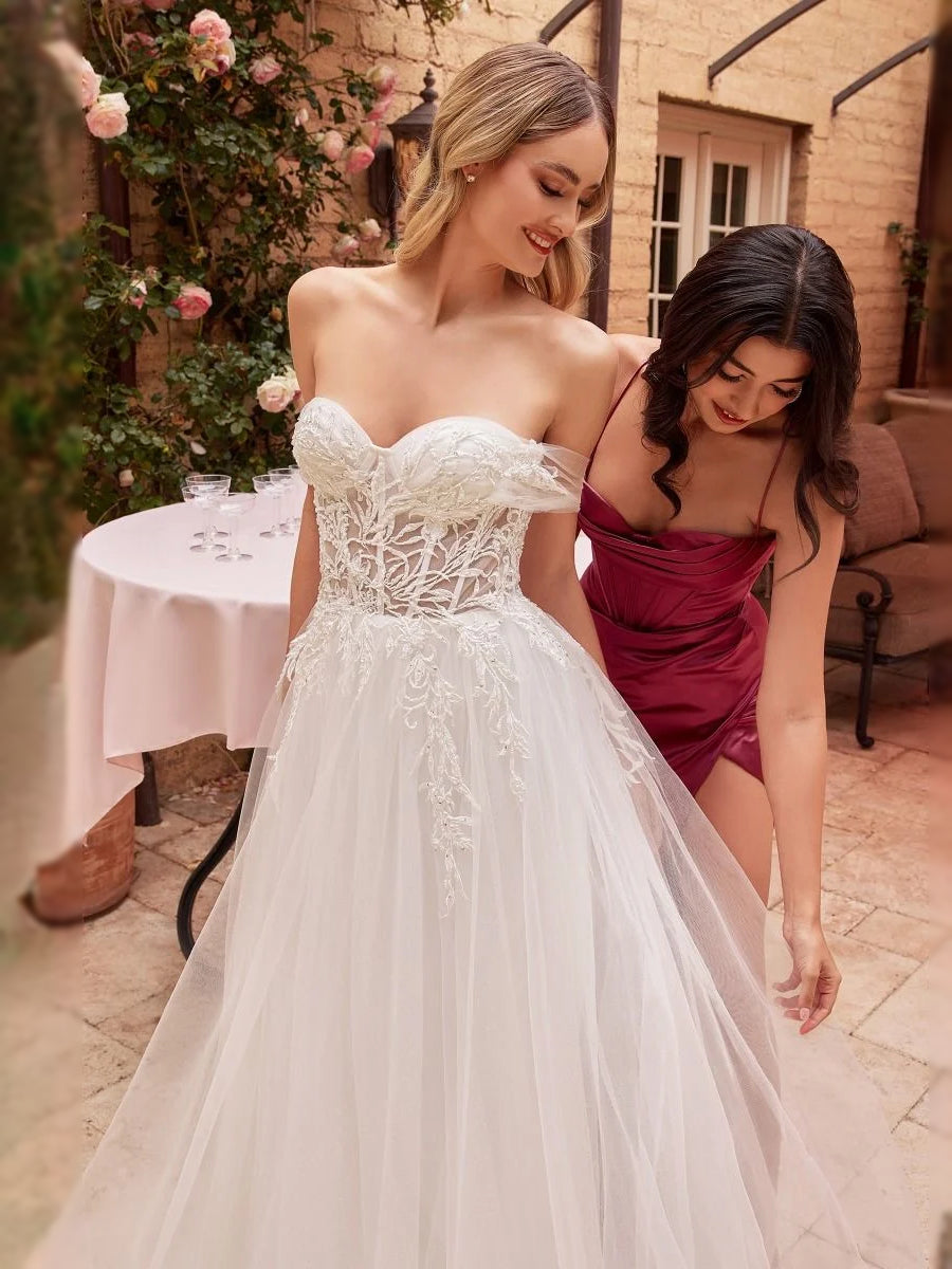 White floral lace sweetheart corset wedding dress with layered tulle skirt and soft train