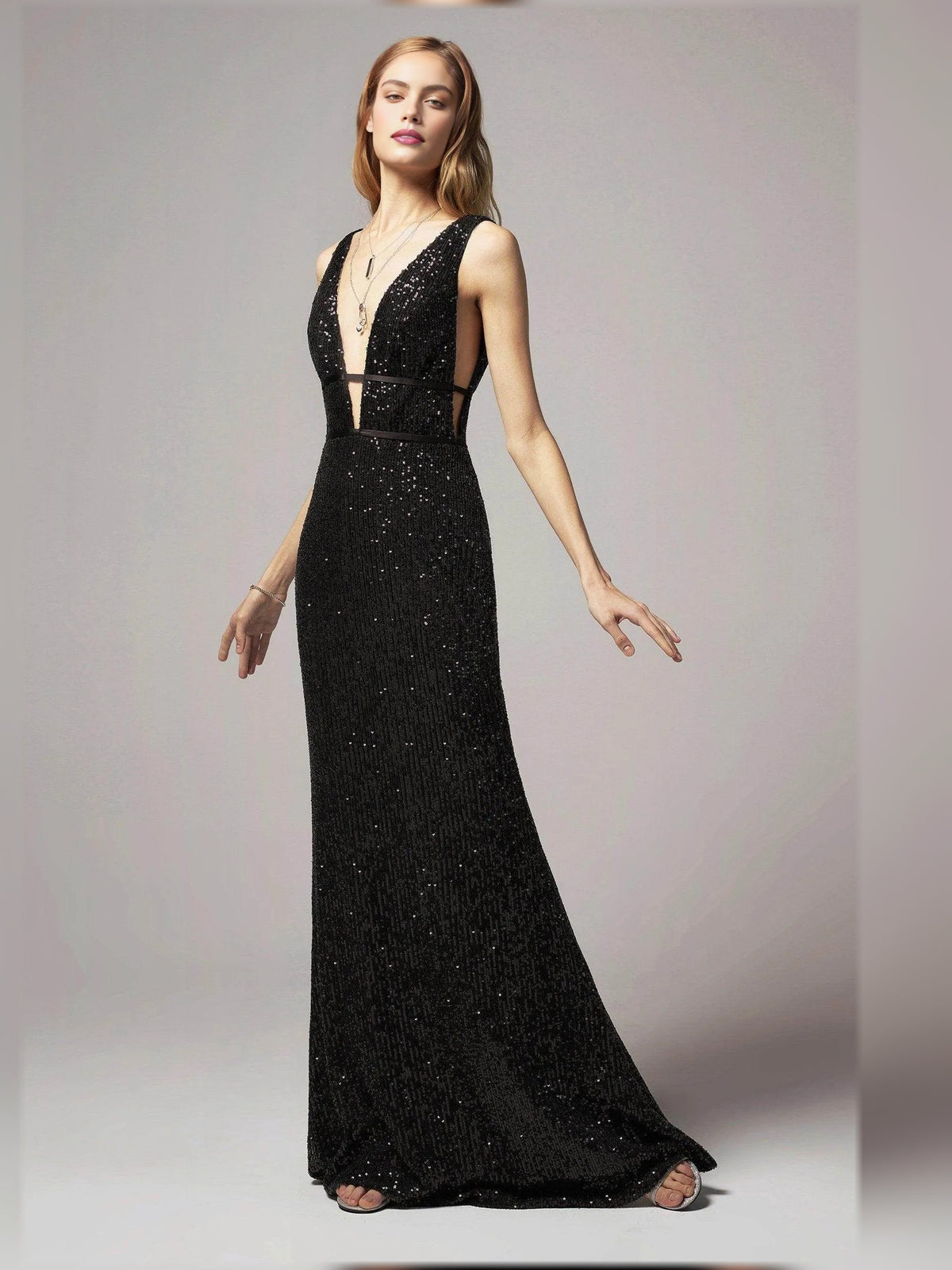 Black beaded open-back sheath floor-length formal dress, relaxed hand pose