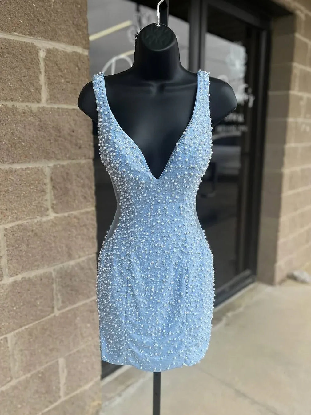Light blue beaded V-neck mini dress on mannequin, sleeveless