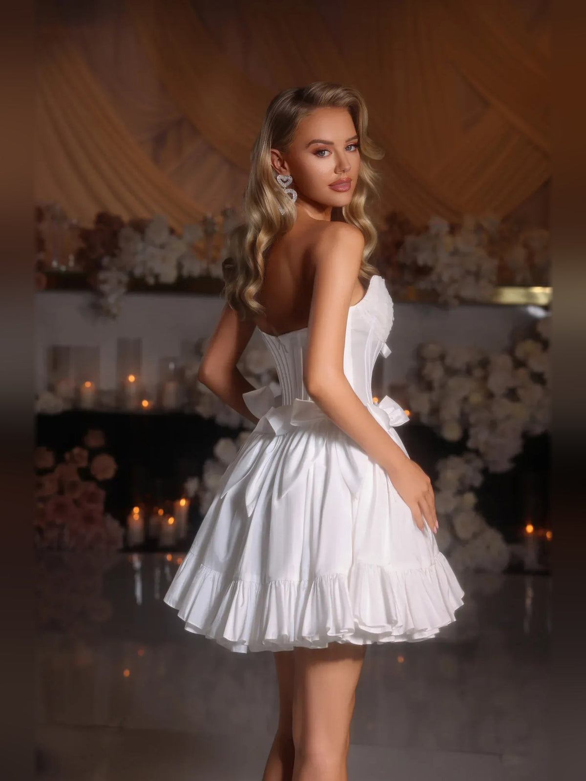 White strapless satin corset mini dress with layered ruffles and bow trim detail