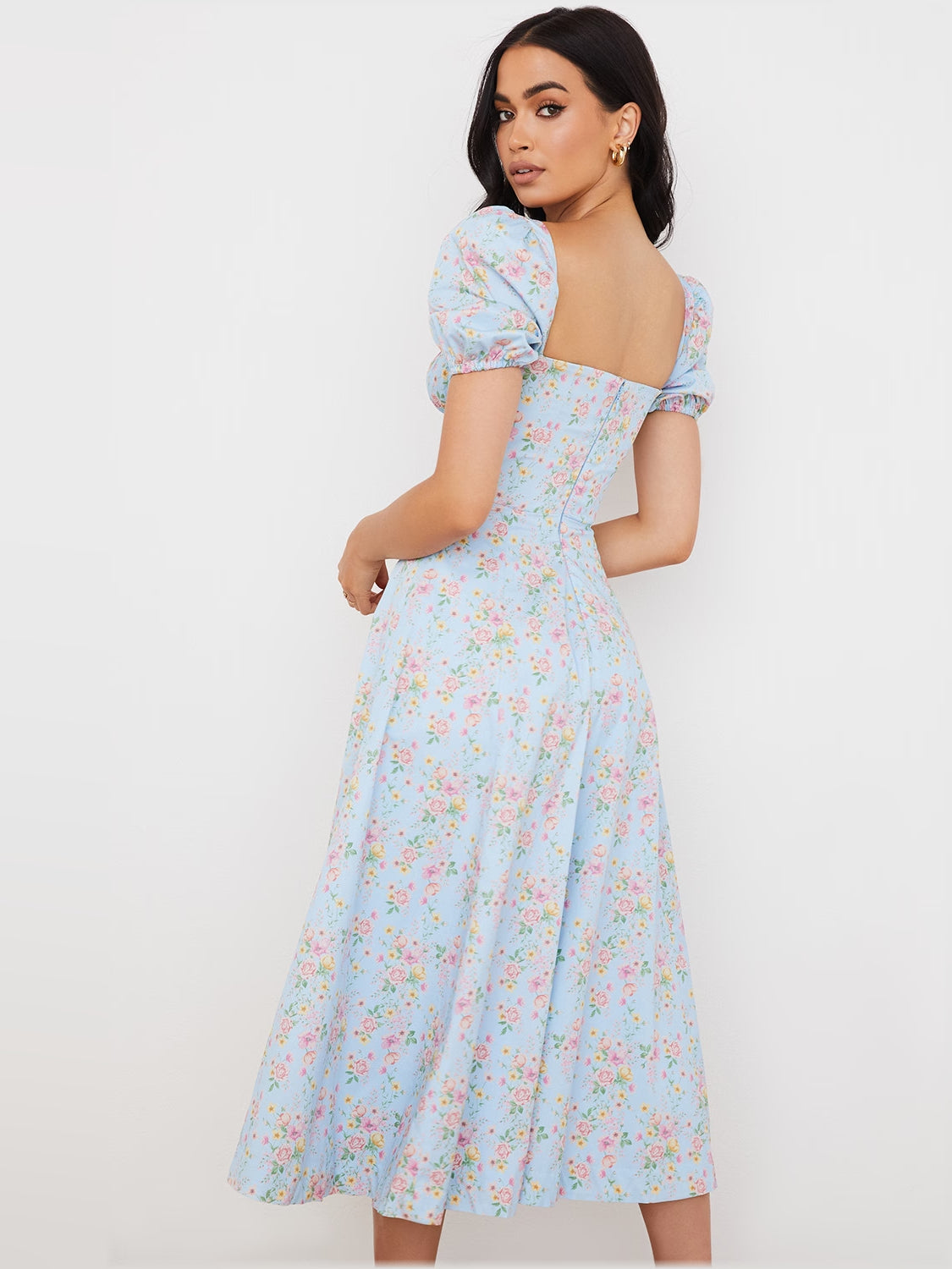 Back view of light blue floral midi dress with puff sleeves and gathered waist