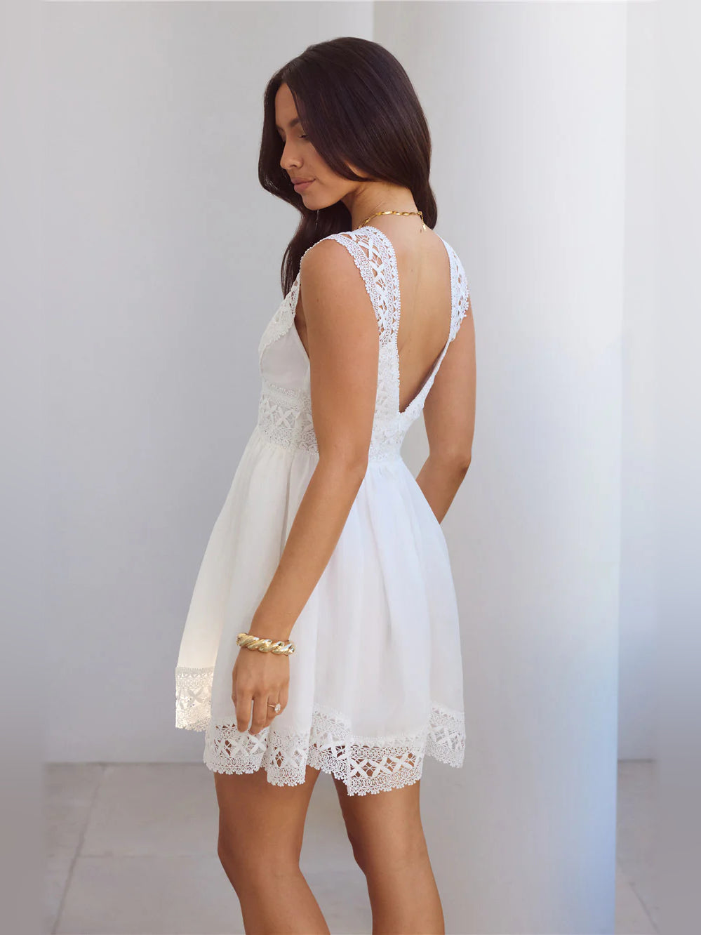 White lace V-neck cap-sleeve A-line mini dress, open-back lace design