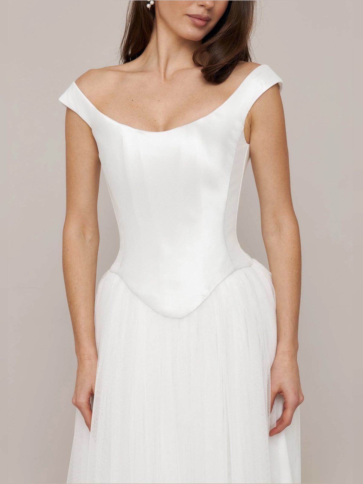 Ivory off-shoulder satin wedding dress with corset bodice and pleated A-line skirt