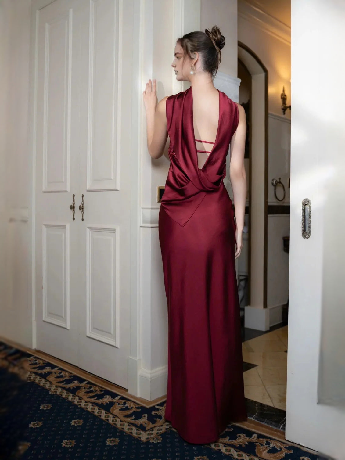 Deep red satin maxi prom dress with draped neckline and open back detail