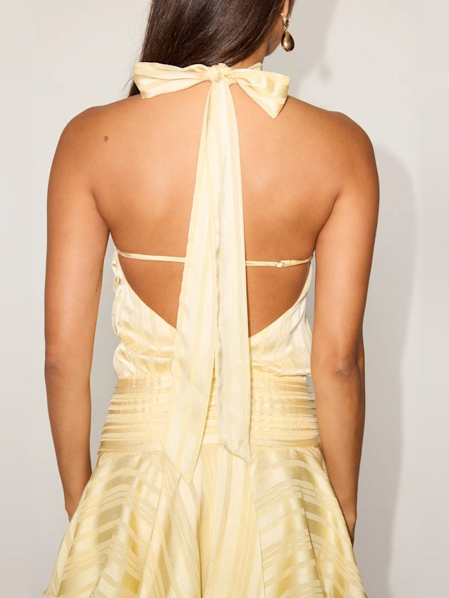 Light yellow satin mini dress back with bow halter tie and open crisscross straps