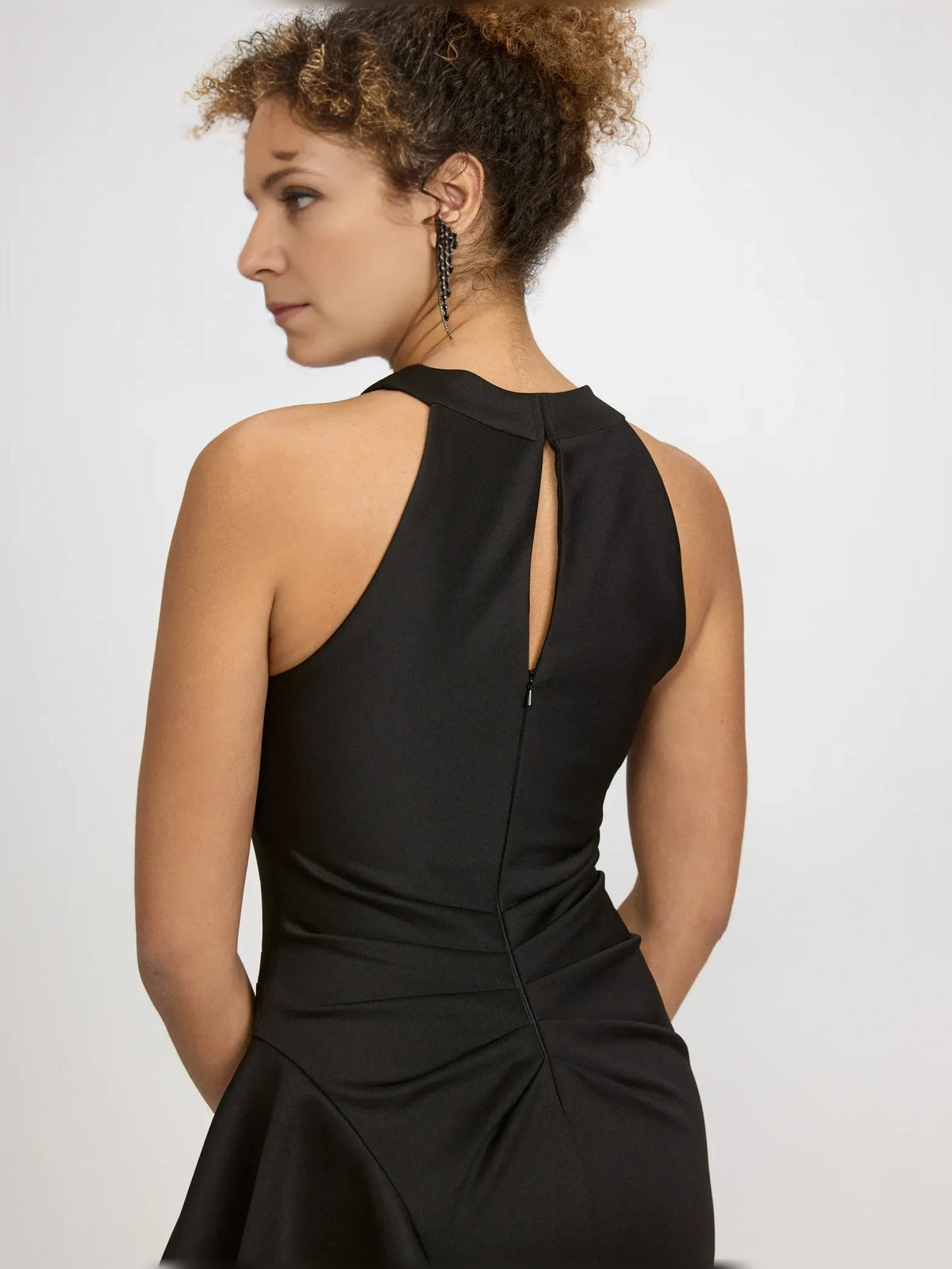 Back view: black halter-neck formal dress with open keyhole back and floor length