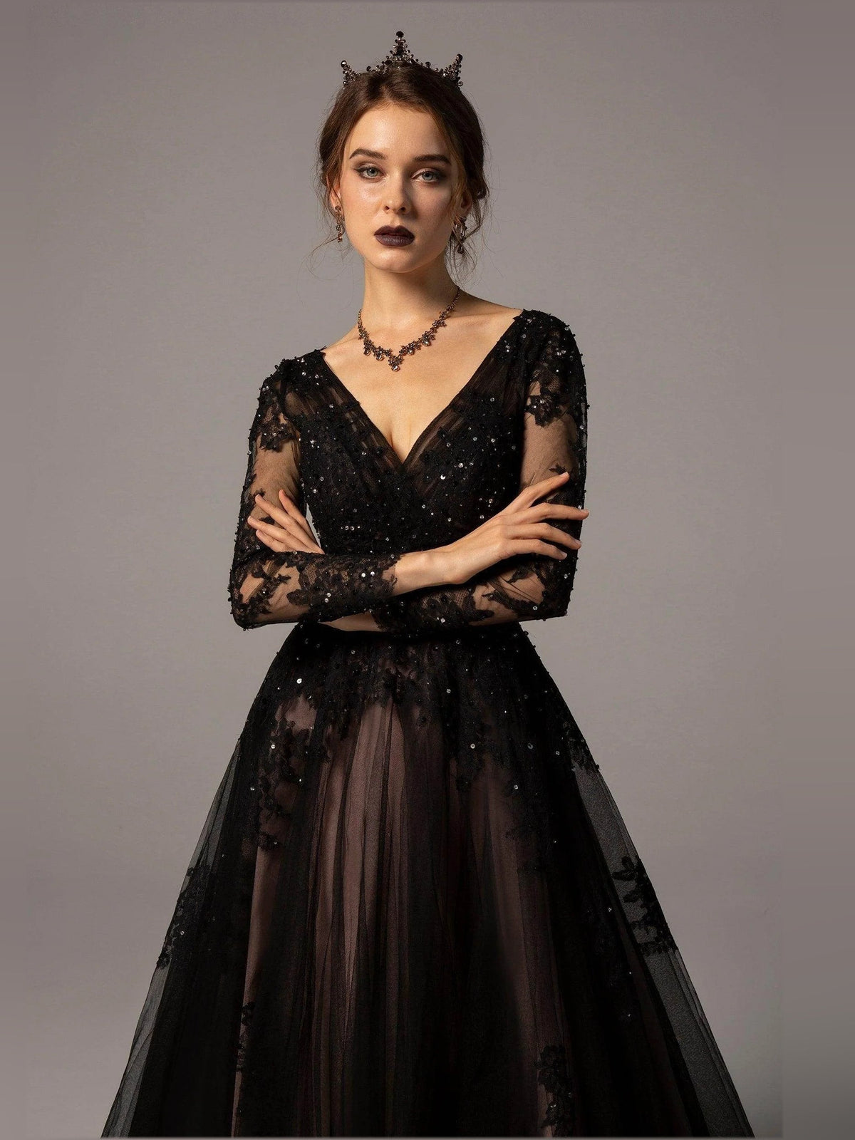 Black V-neck corset wedding dress with glittering lace bodice and sheer floral long sleeves