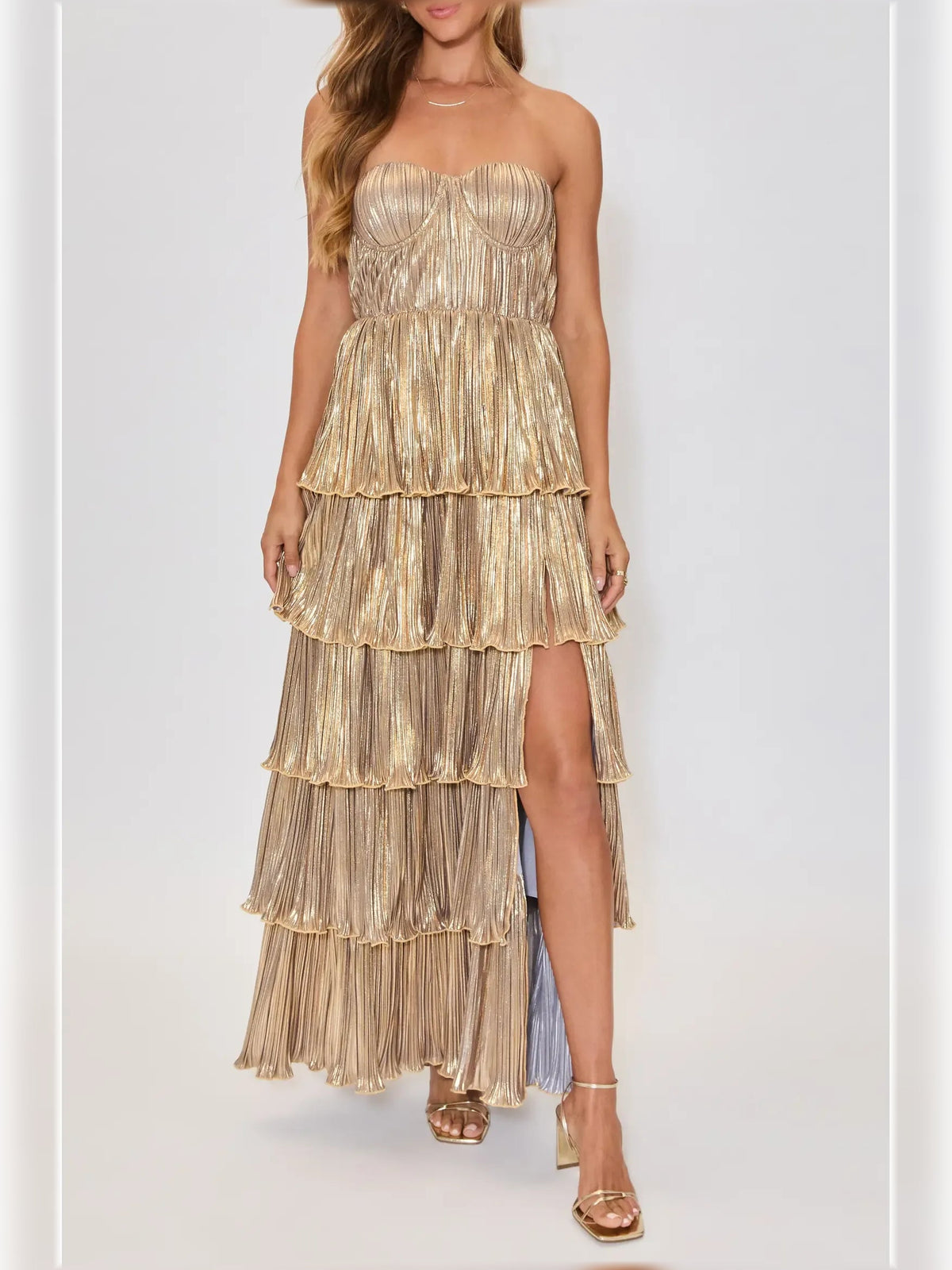 Gold strapless pleated tiered formal dress with gathered bodice