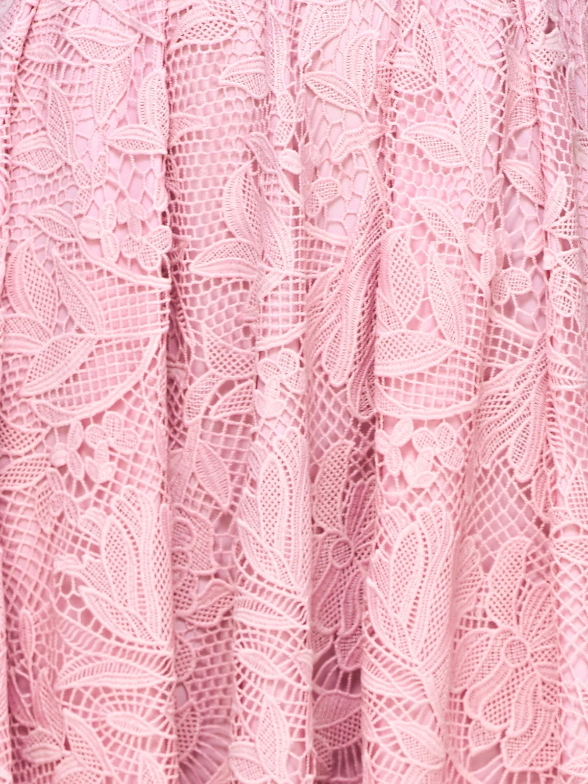 Pink floral lace fabric with raised floral motifs and scalloped lace edges
