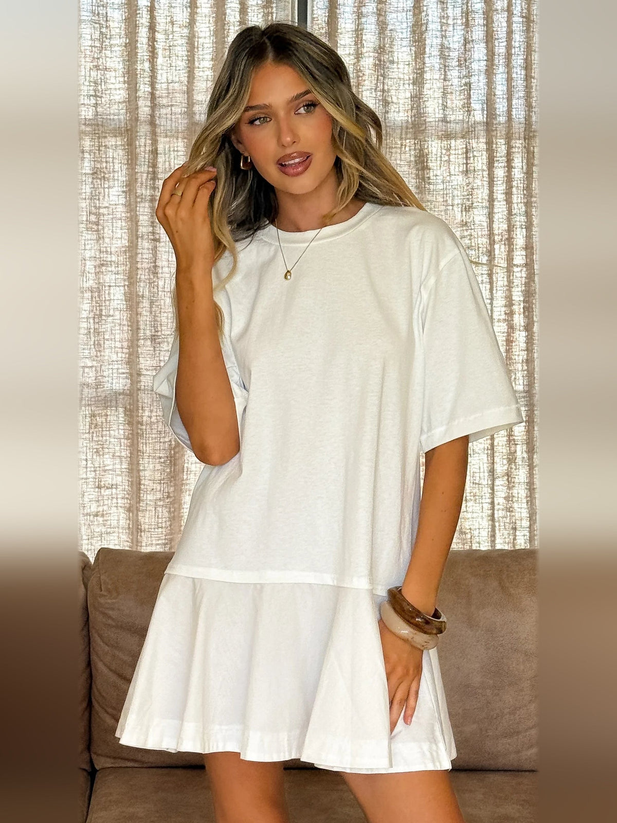Off-white mini dress with short sleeves and tiered skirt, crew neckline