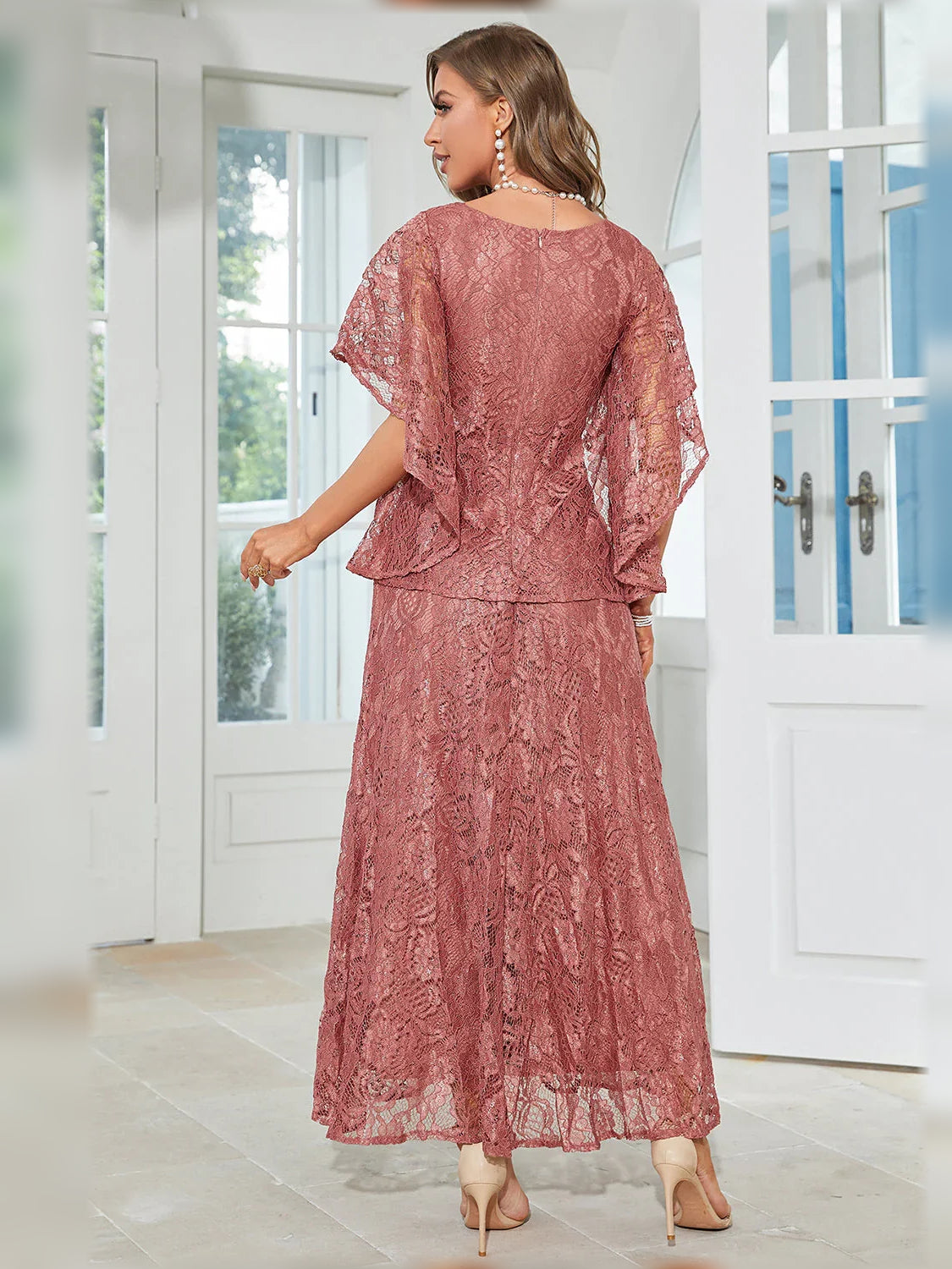 Dusty rose lace A-line formal dress with sheer cape sleeves and full-length skirt, back view