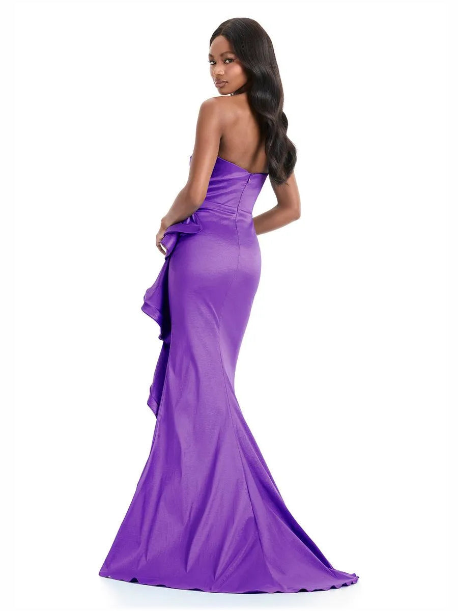 Purple strapless formal gown with ruching and ruffled drape detail