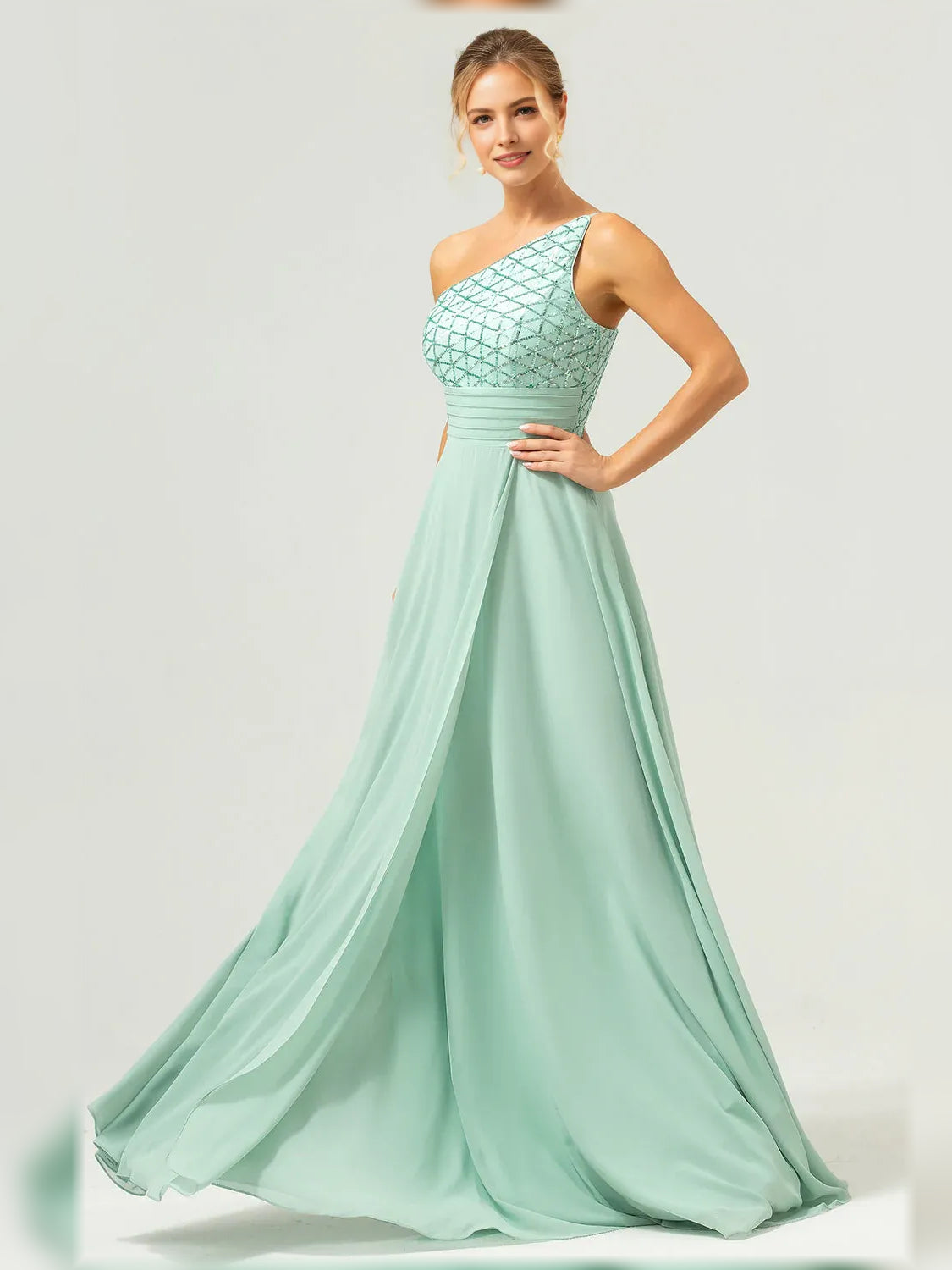 Mint green one-shoulder formal gown with pleated skirt and beaded bodice detail