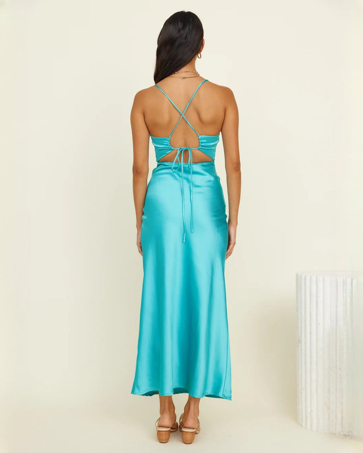 Aqua satin sleeveless maxi dress, back view with crossed straps and tied waist