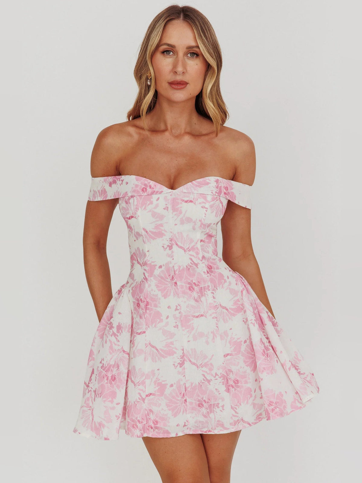 Pink floral off-shoulder mini dress with structured sweetheart neckline and flounce skirt