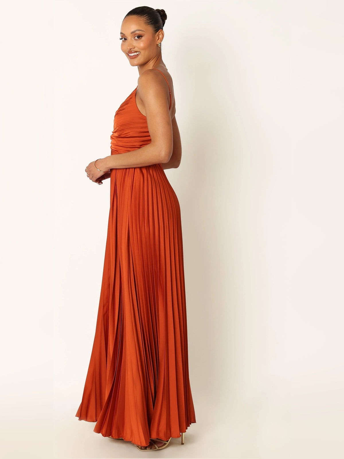 Orange pleated maxi dress with spaghetti straps and ruched bodice (side)
