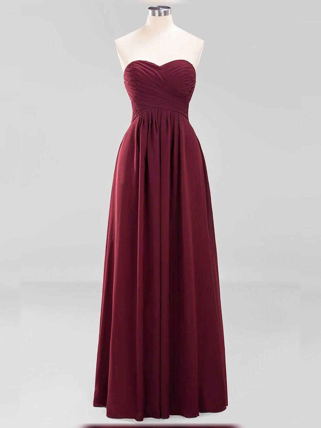Burgundy strapless sweetheart chiffon A-line dress on mannequin, pleated floor-length skirt