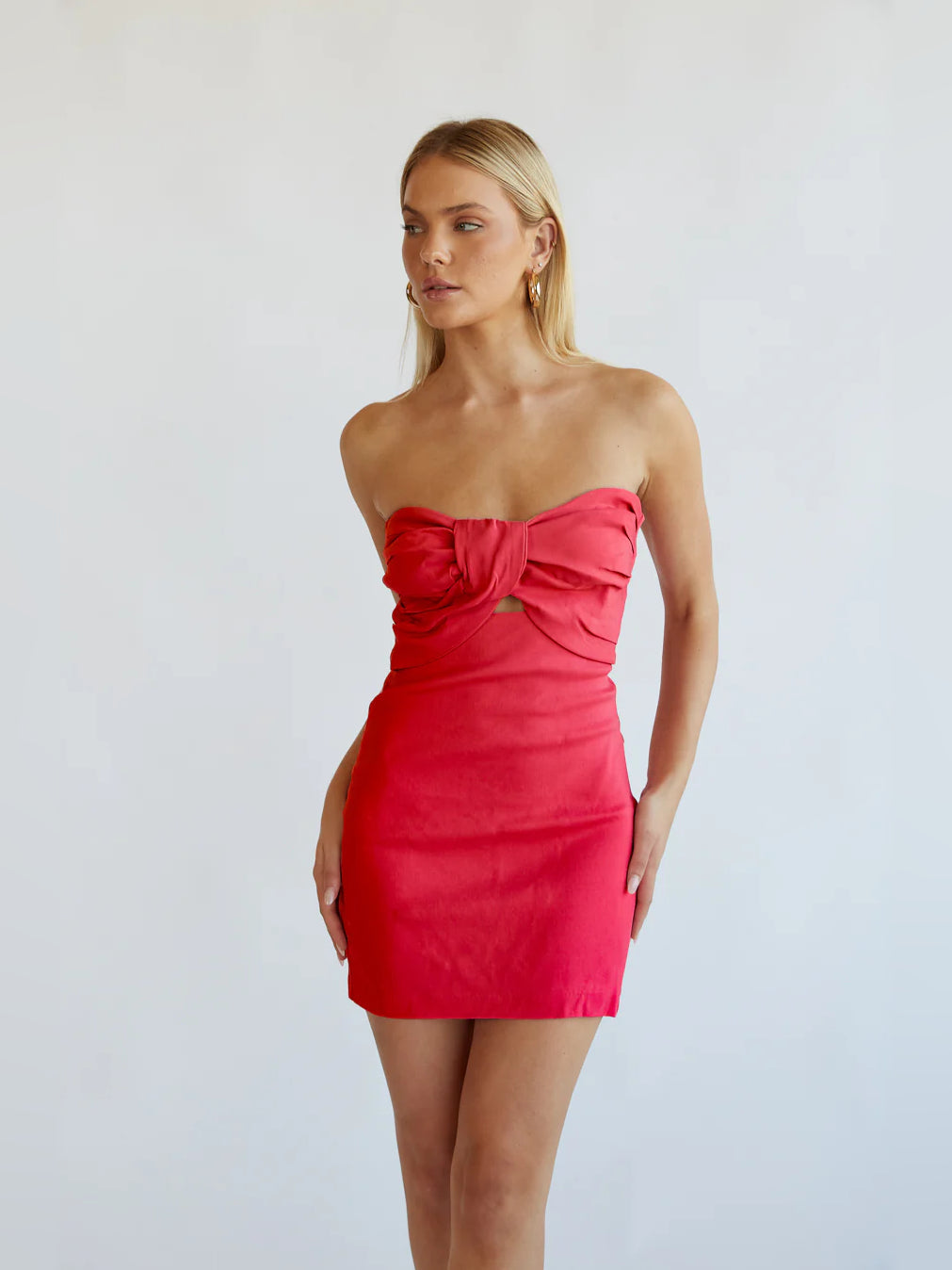 Red mini strapless dress with large gathered bow at the bust and bodycon fit