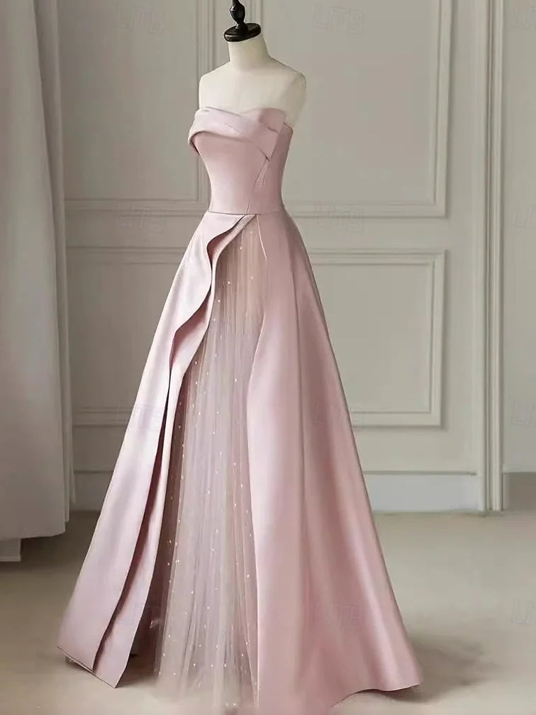Blush pink strapless sweetheart satin maxi dress with asymmetric drape and glitter tulle skirt