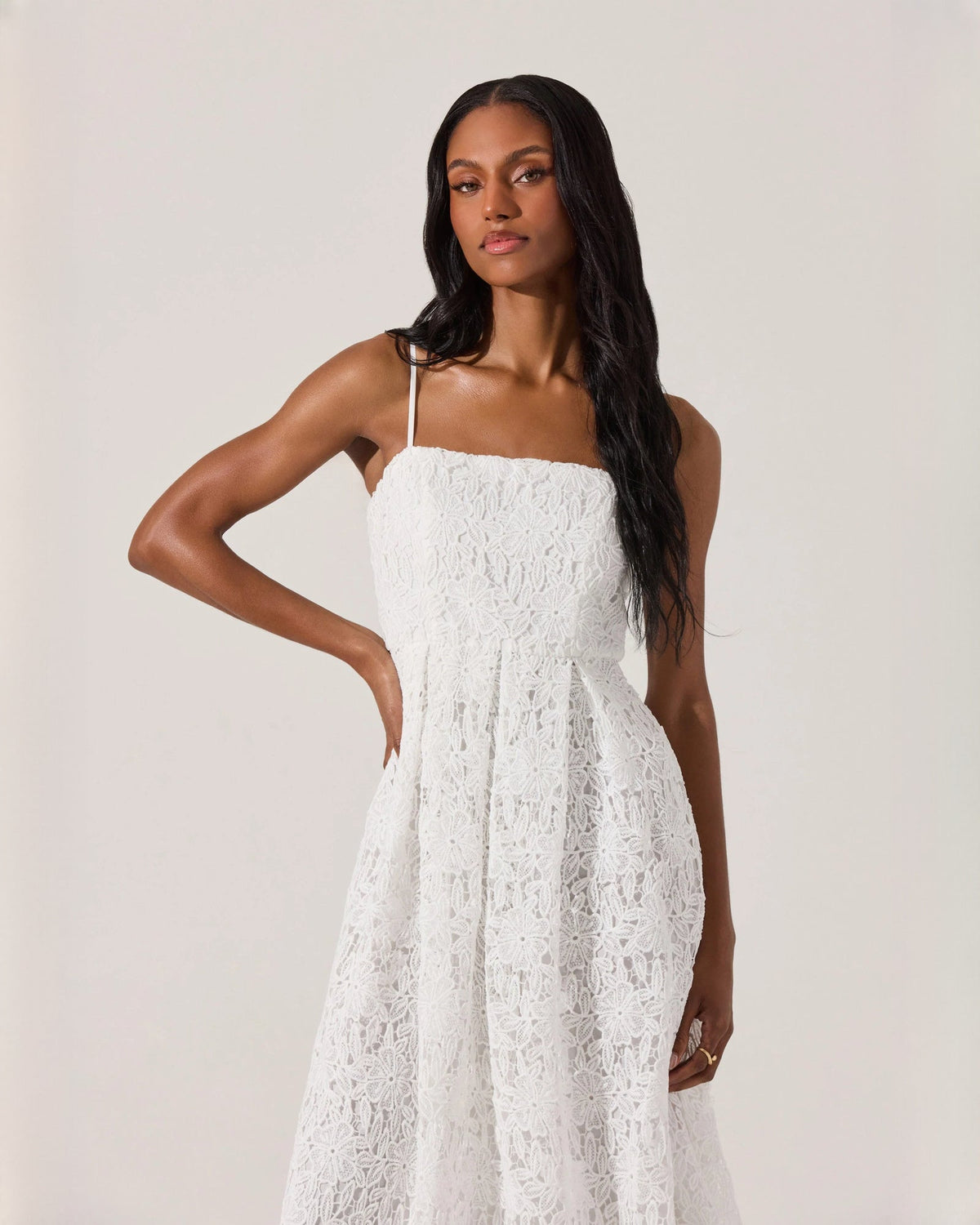 White sleeveless A-line midi dress with spaghetti straps and lace overlay skirt