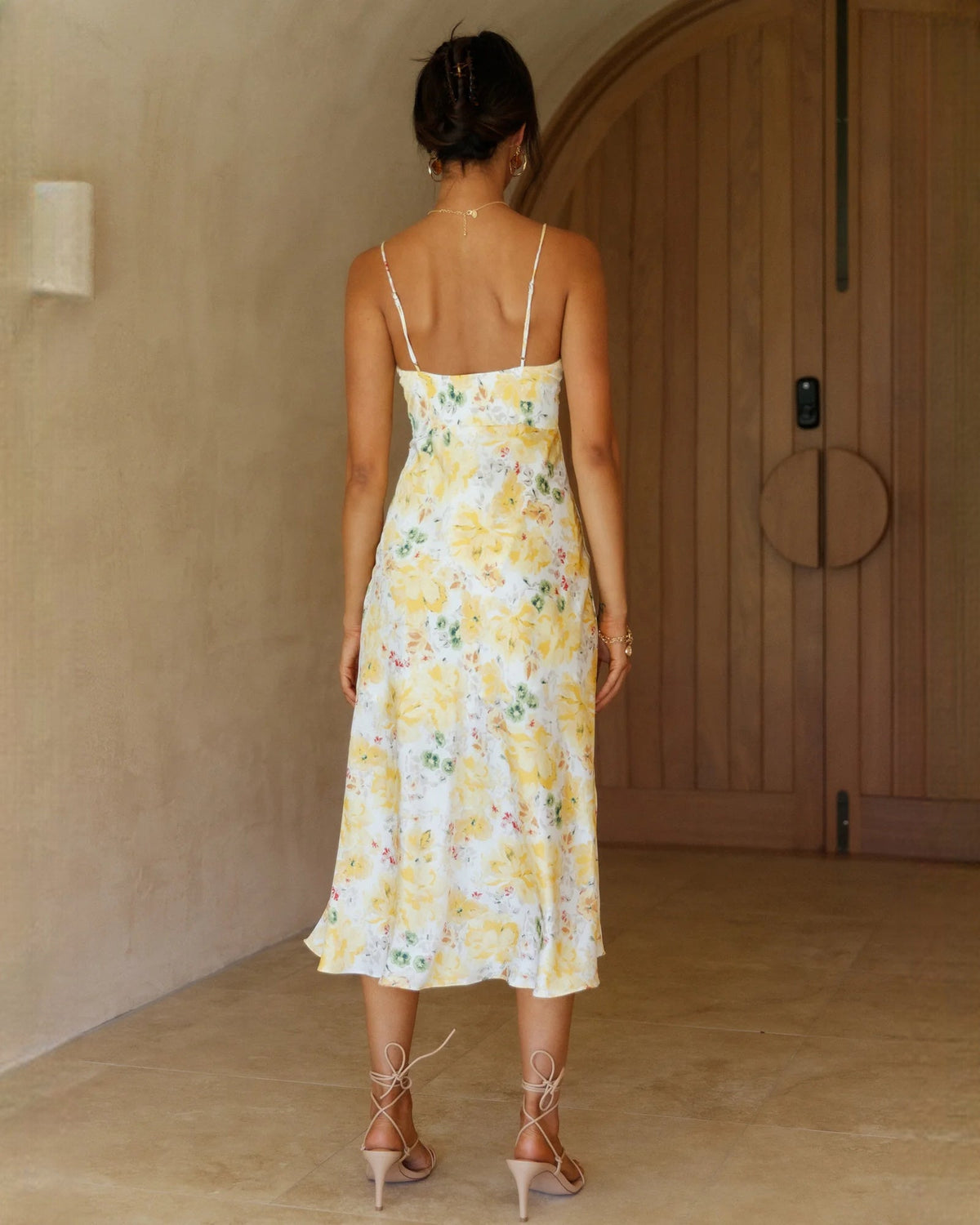 Yellow floral chiffon A-line midi dress, open-back view with thin spaghetti straps