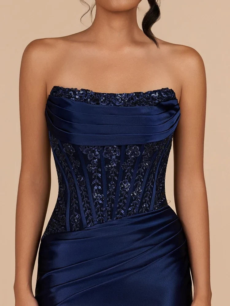 Navy strapless satin mini dress close-up with ruched band and corset beaded front panel