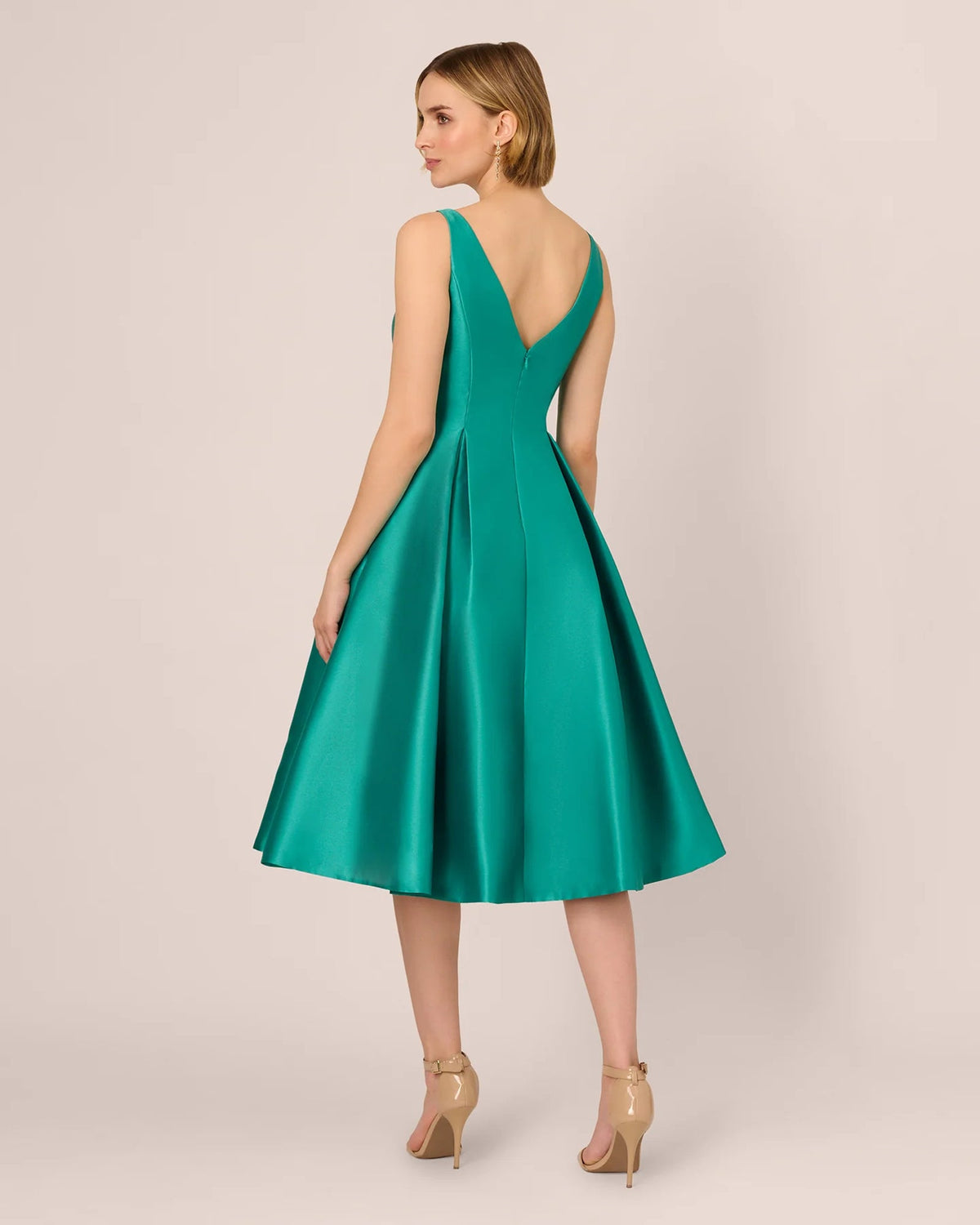 Emerald green backless fit-and-flare midi dress, open V back, waist seam