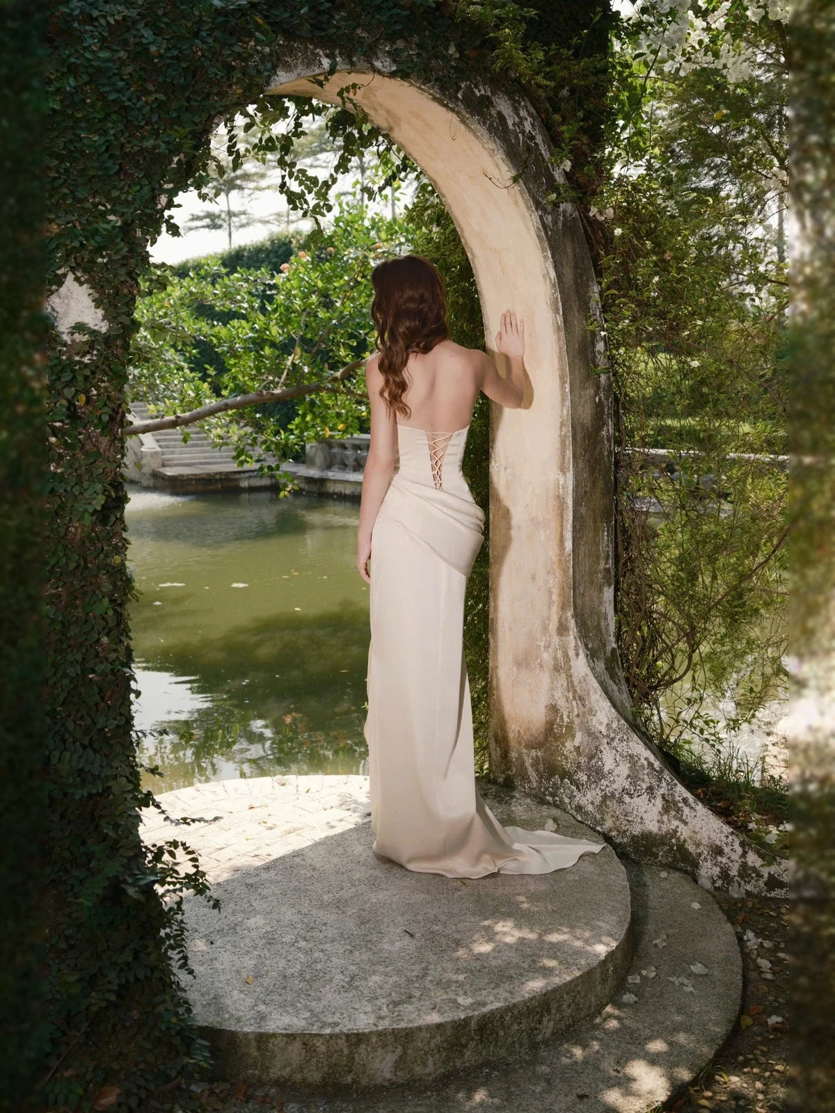 Light blush satin mermaid bridesmaid dress with ruched waist and open back, floor length