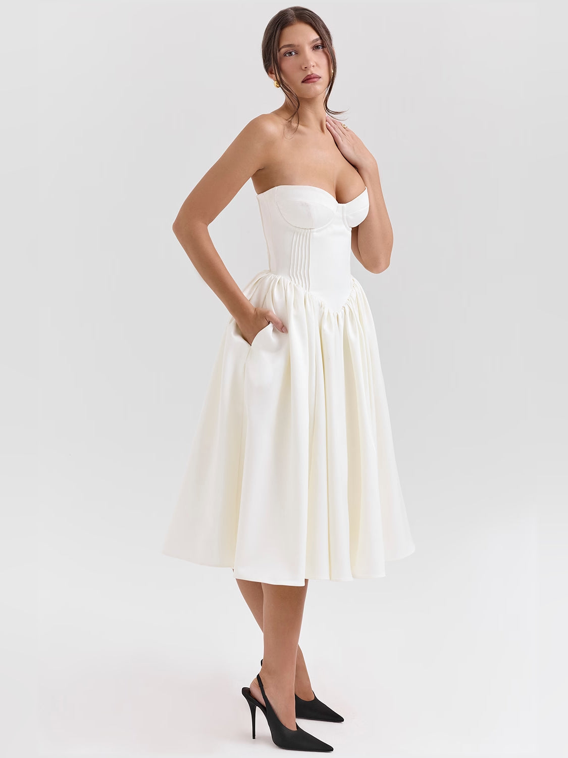 Ivory satin midi dress with strapless bustier bodice and tiered pleated skirt