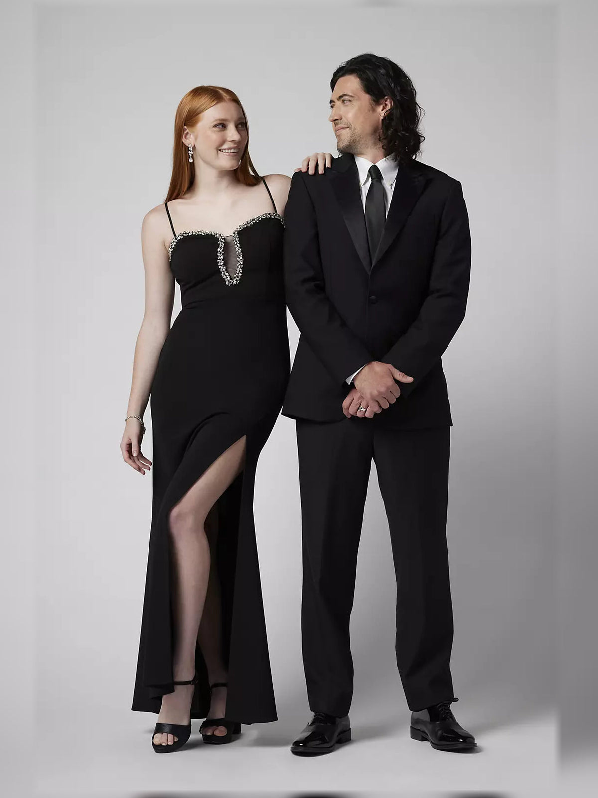 Black formal maxi dress with spaghetti straps, crystal beaded sweetheart neckline, and slit