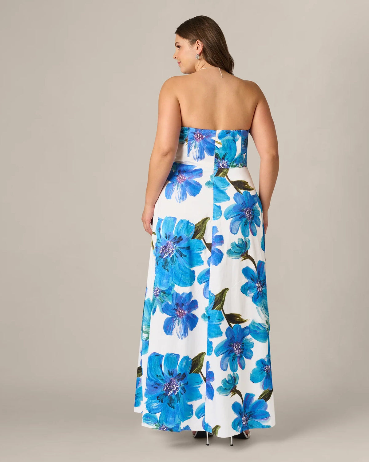 Back view of strapless A-line maxi dress with blue floral print on ivory