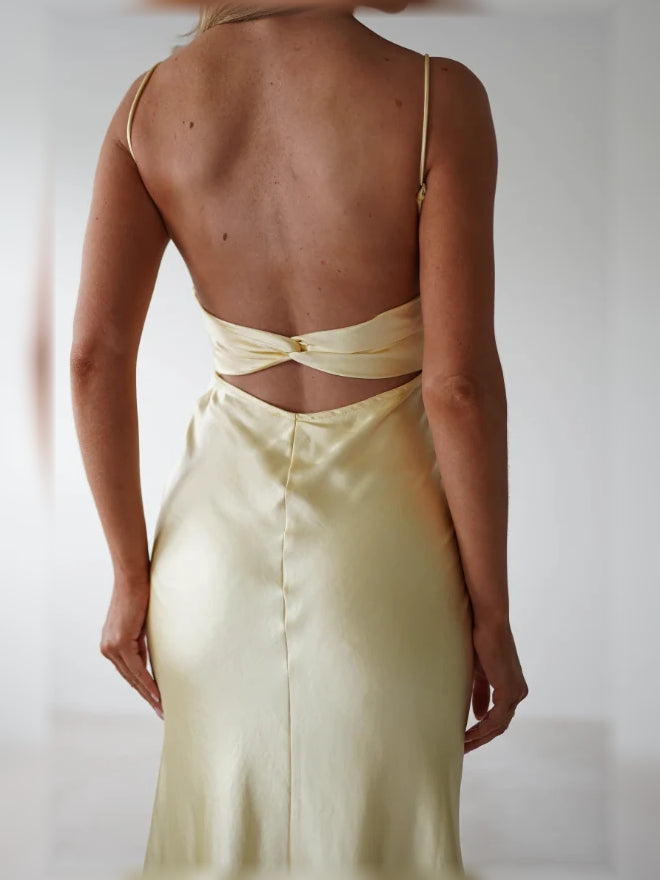 Yellow satin maxi bridesmaid dress with open back and tied bow at the upper back