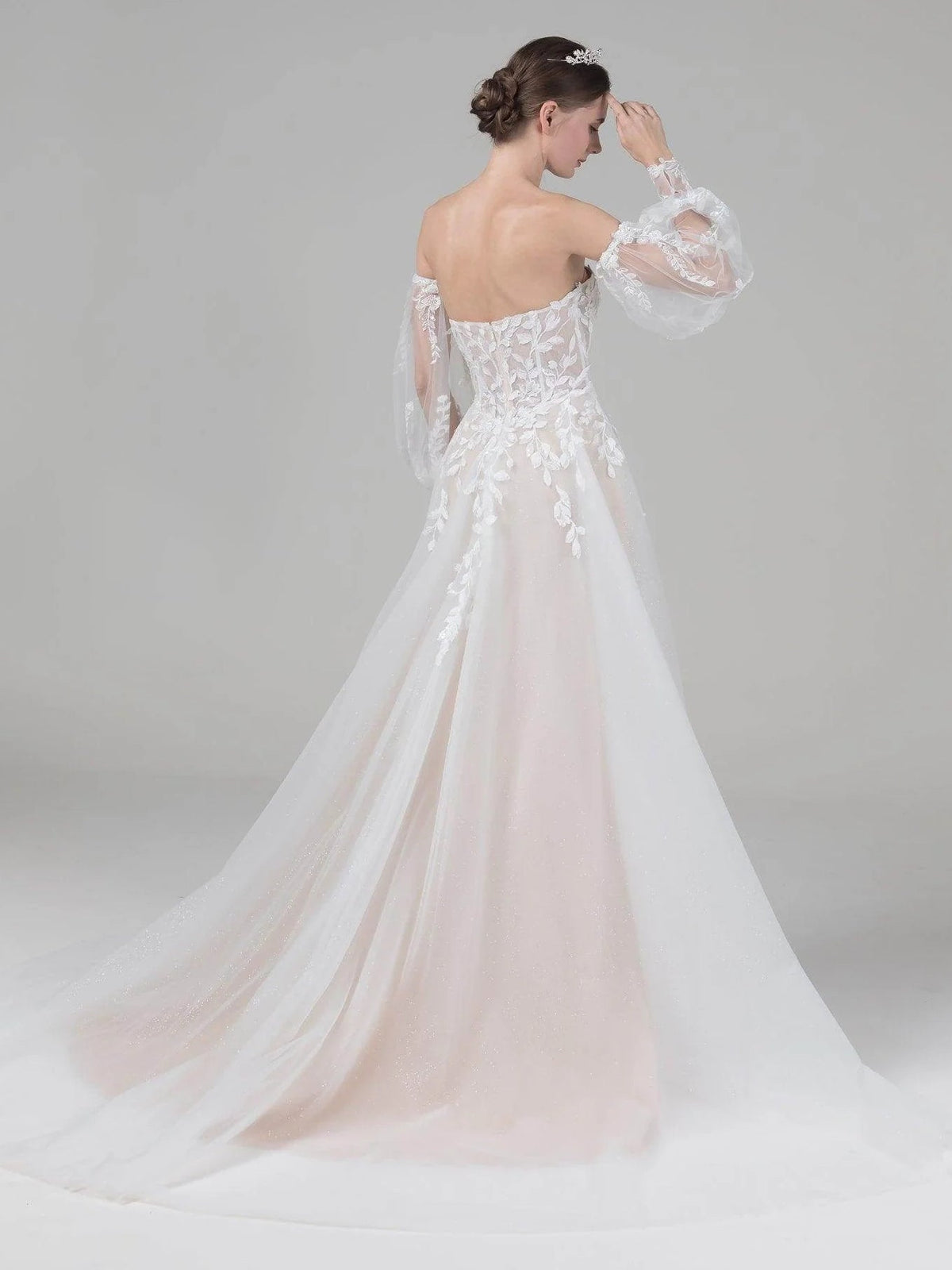 Ivory lace A-line wedding dress with off-shoulder sleeves and long tulle skirt, back view
