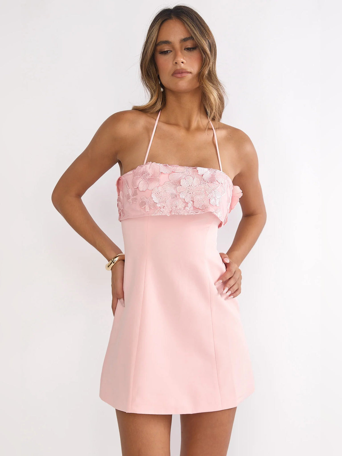 Blush mini homecoming dress with floral lace ruffle bodice and spaghetti straps, front