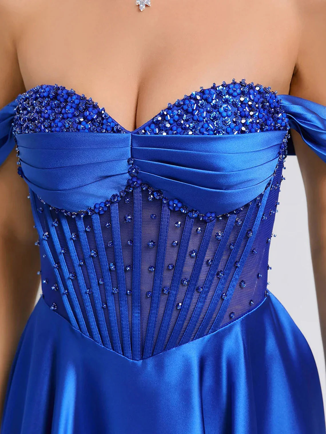 Cobalt blue corset bodice with beadwork and off-shoulder satin sleeves