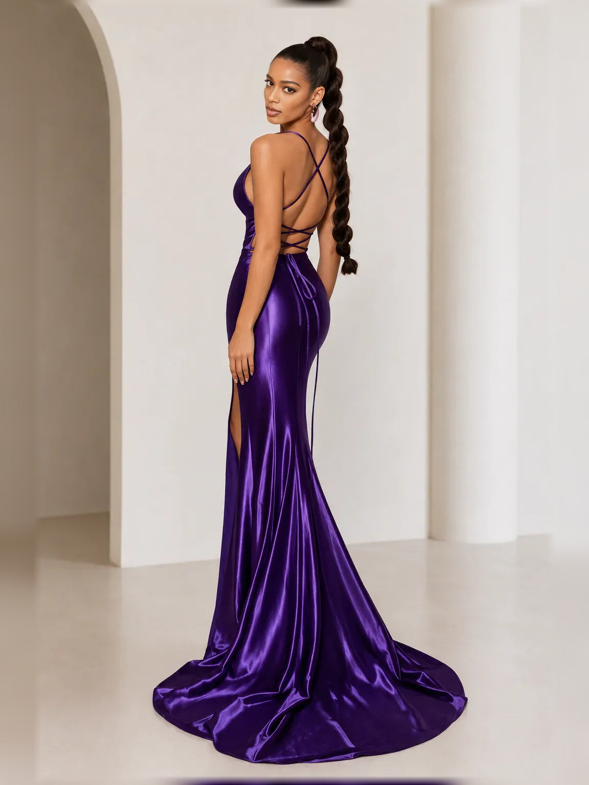 Purple cowl-neck formal gown with spaghetti straps, fitted bodice and side slit.