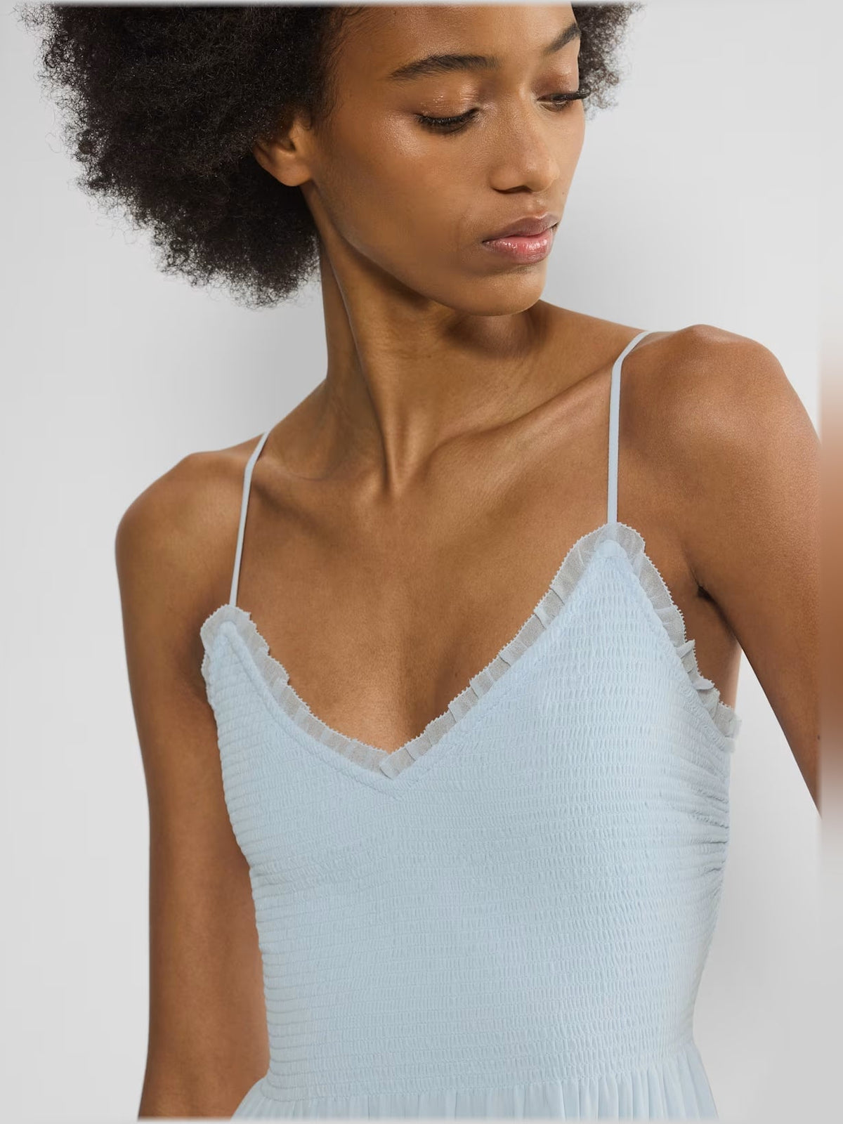 Light blue chiffon bodice with V-neck, thin straps, and smocked waist detail