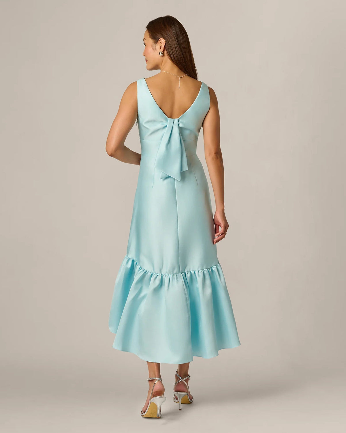 Pale aqua sleeveless midi dress with open back and tied neckline, ruffle skirt