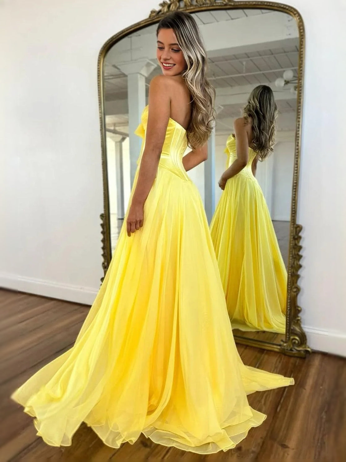 Yellow strapless corset A-line prom dress with bow bodice and airy tiered skirt
