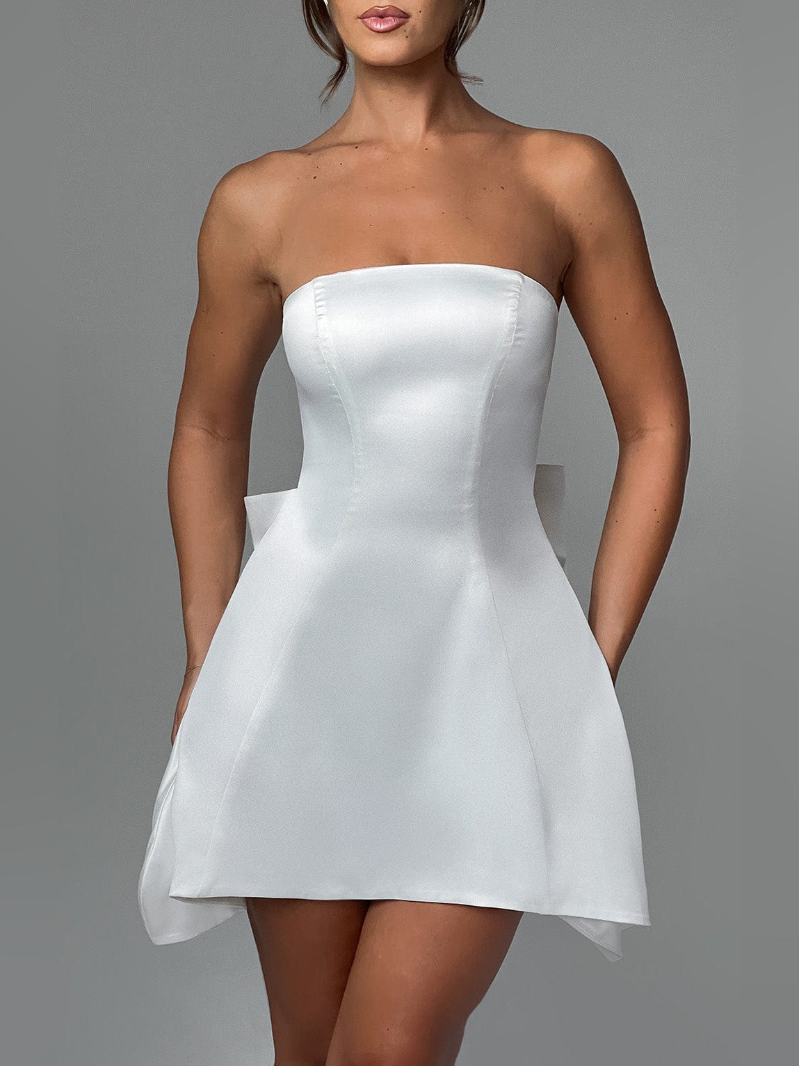 Ivory strapless mini dress with fitted bodice and flared skirt with side tails