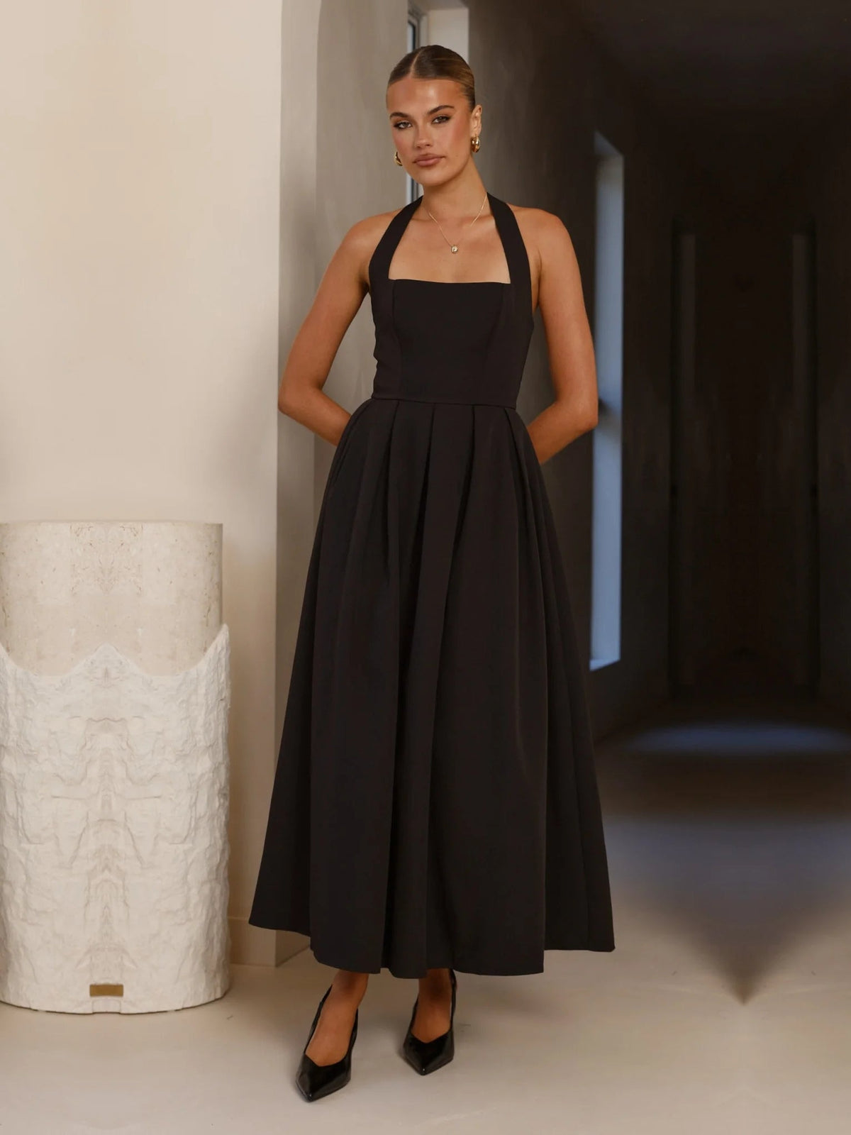 Black a-line maxi formal dress with halter neckline, alternate view showing the skirt