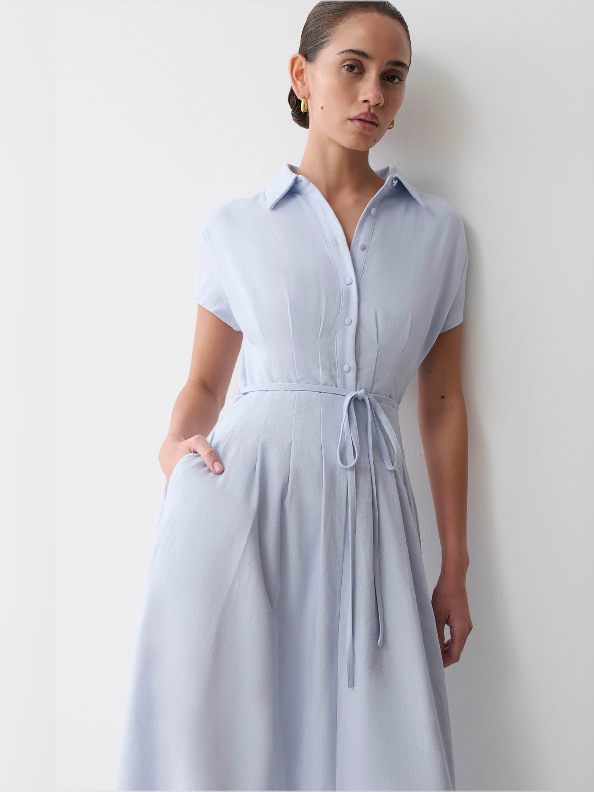 Cornflower blue linen midi dress close view: shirt collar, buttons, and waist tie