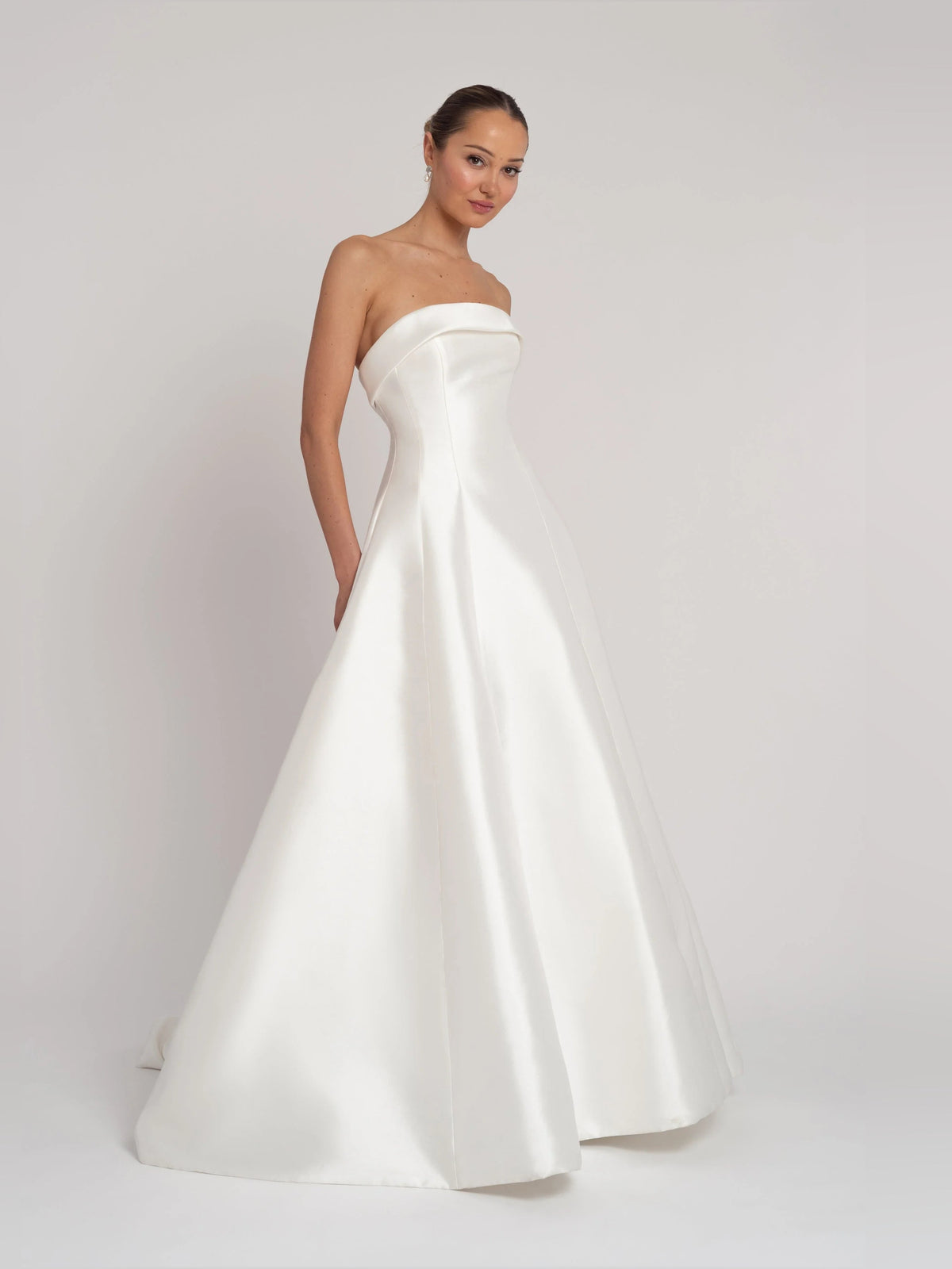 Ivory strapless satin wedding dress with structured bodice and A-line skirt