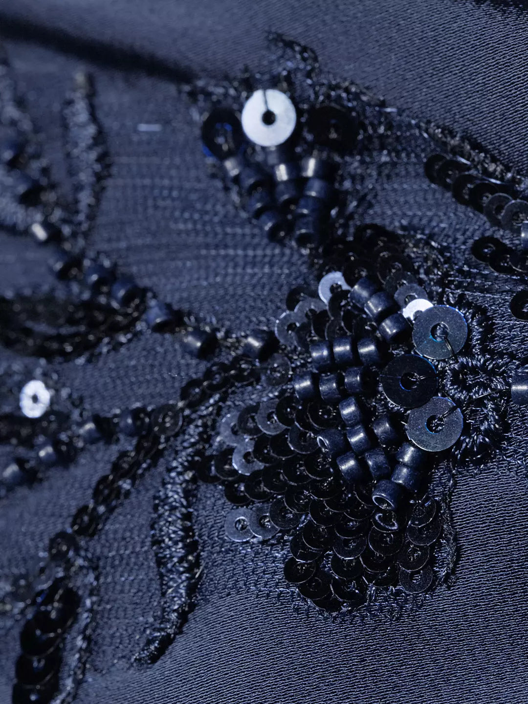 Close-up: dark navy satin with black beaded sequin floral embroidery